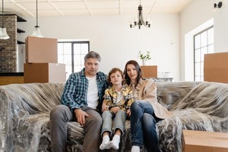 An upgrade to a nicer home that suits your lifestyle will benefit your mental health. A family sitting on a couch