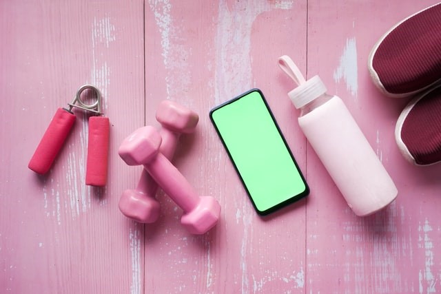 Pack smaller items into cardboard boxes and label them pink gym accessories